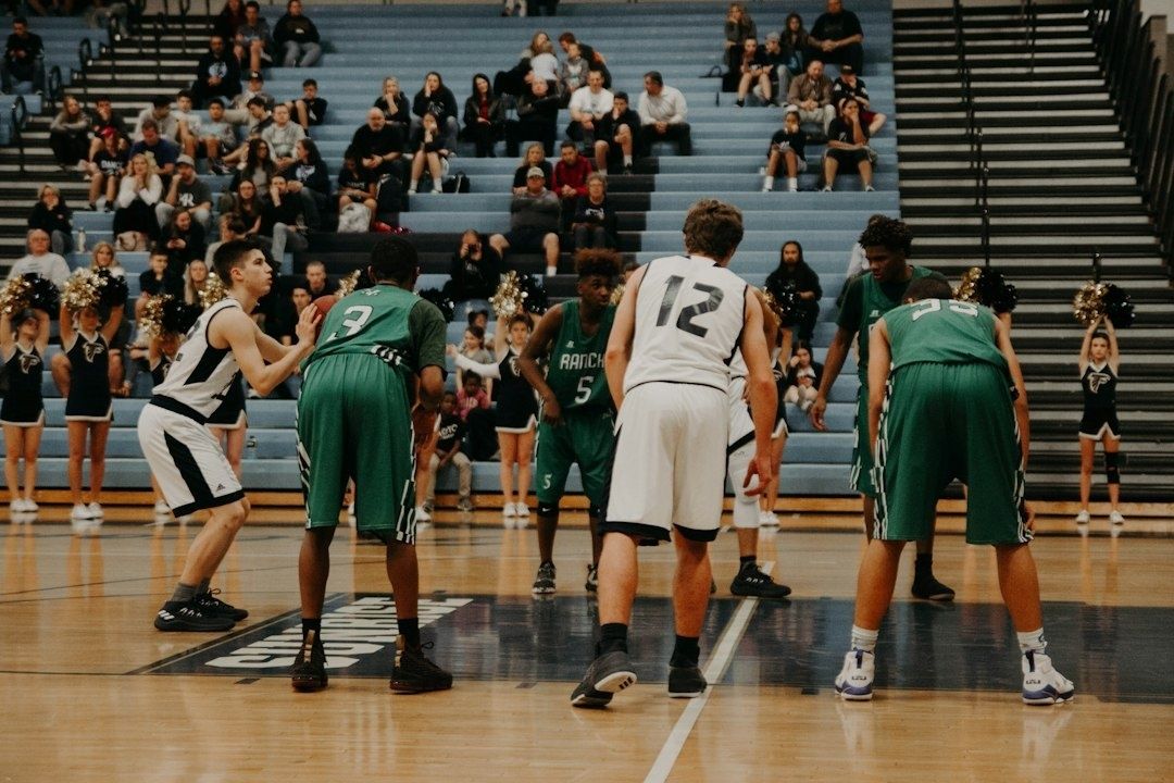 College basketball players line up around the key during a free throw