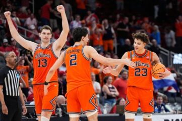 Three Illinois basketball players celebrate during a game